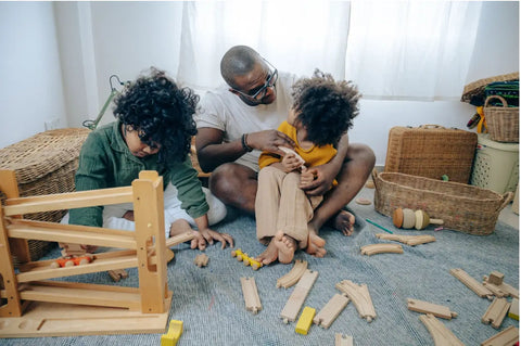 Family playing with toy train set