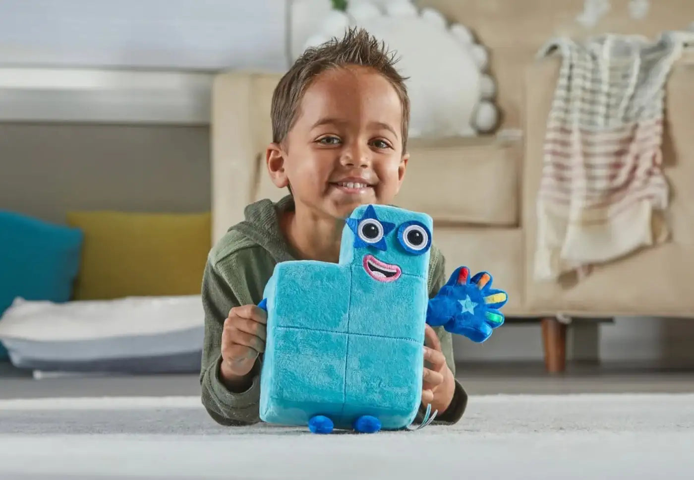 Blue plush toy with white eyes and hands, designed for children.