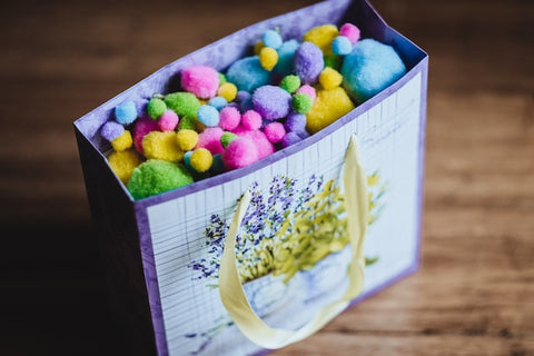 Paper Gift Bag full of multicoloured felt balls