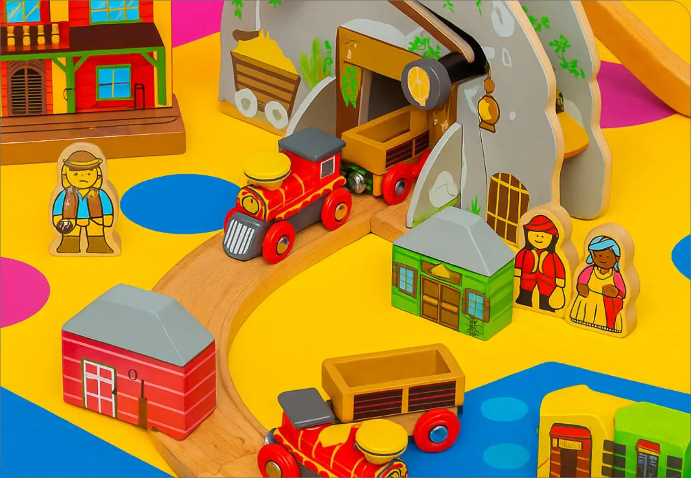 Red wooden train set with tunnel and figures.